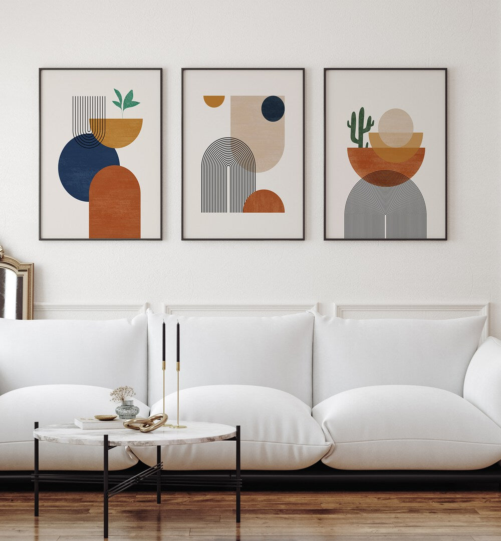 Boho Dessert Geometry Set Of 3 Paintings in Black Plain Frame placed on a white wall beside a window and behind a sofa