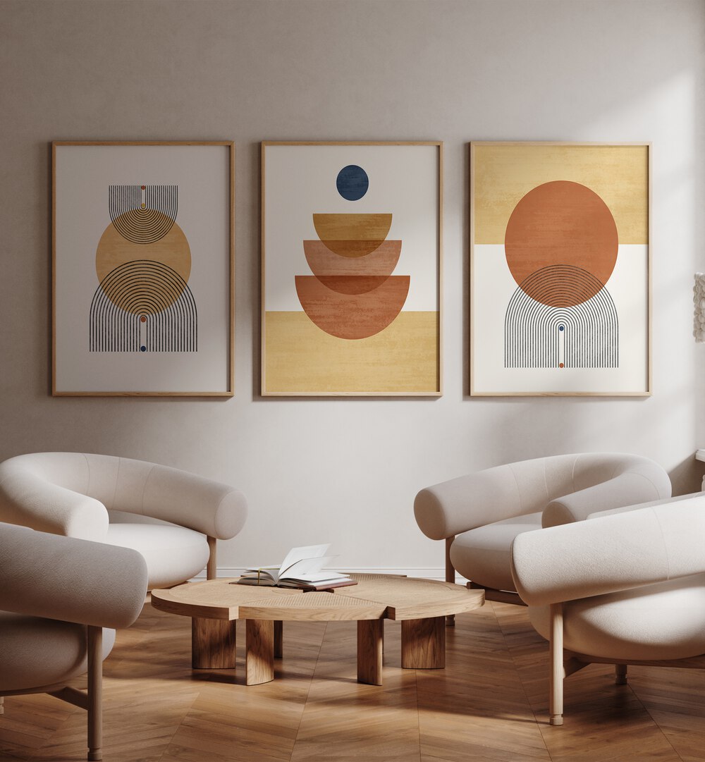 Boho Geometrical Awakenings Set Of 3 Paintings in Oak Wood Plain Frame placed on a wall beside chairs and a table