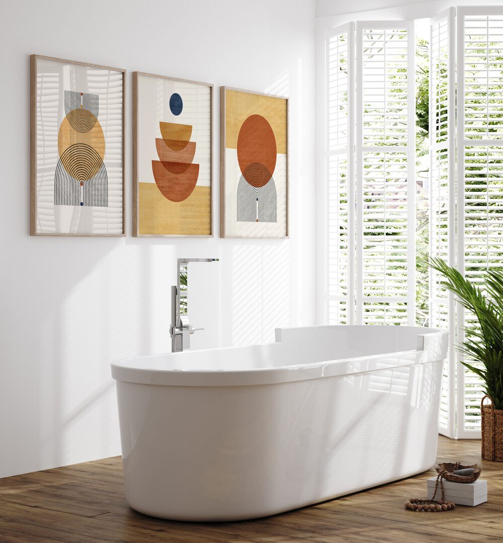 Boho Geometrical Awakenings Set Of 3 Paintings in Oak Wood Plain Frame placed on a bathroom wall beside a bathtub