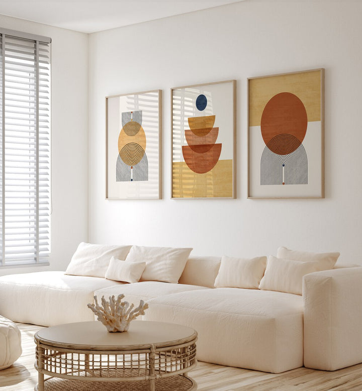 Boho Geometrical Awakenings Set Of 3 Paintings in Oak Wood Plain Frame placed on a wall living room wall behind a sofa