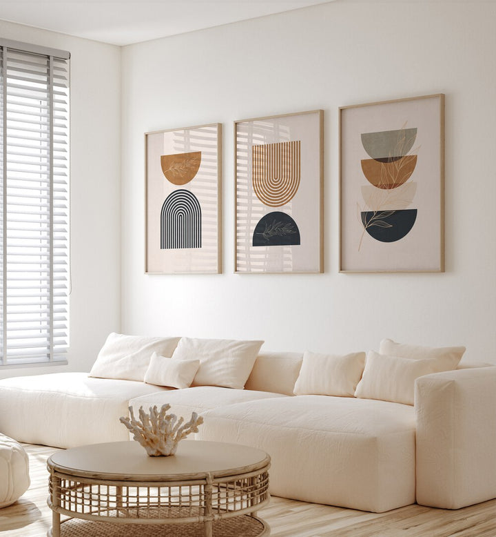 Boho Geometrical Shapes I Set Of 3 Paintings in Oak Wood Plain Frame placed on a wall living room wall behind a sofa 