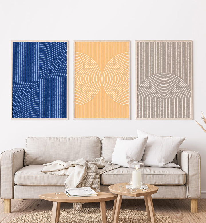 Boho Patterns In Pastel Colors Set Set Of 3 Paintings in Oak Wood Plain Frame placed on a white wall behind a sofa for living room