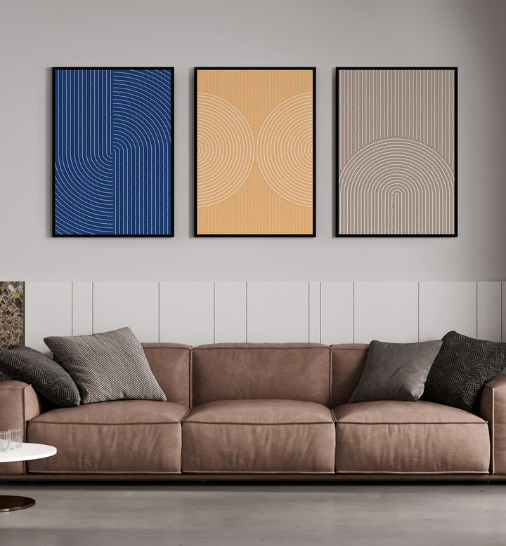 Boho Patterns In Pastel Colors Set Set Of 3 Paintings in Black Plain Frame placed on a living room wall behind a brown sofa