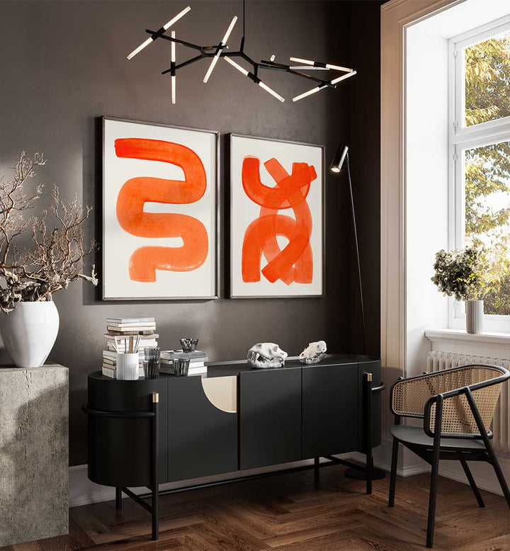 Modern interior with abstract orange art on a gray wall, black sideboard, and decorative items.