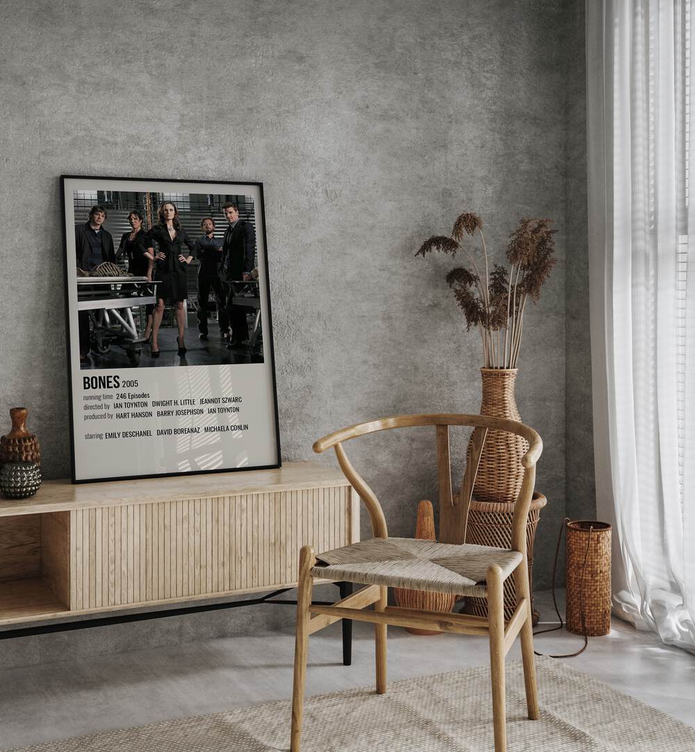 Bones 2005 Movie Posters in Black Plain Frame placed on a table beside oakwood chair