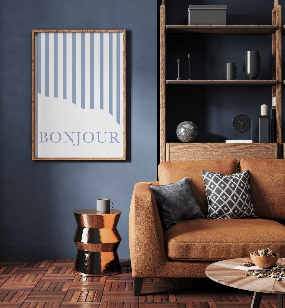 Bonjour By Grace Digital Art Co Quotes And Typography in Oak Wood Plain Frame placed on a blue wall beside a sofa