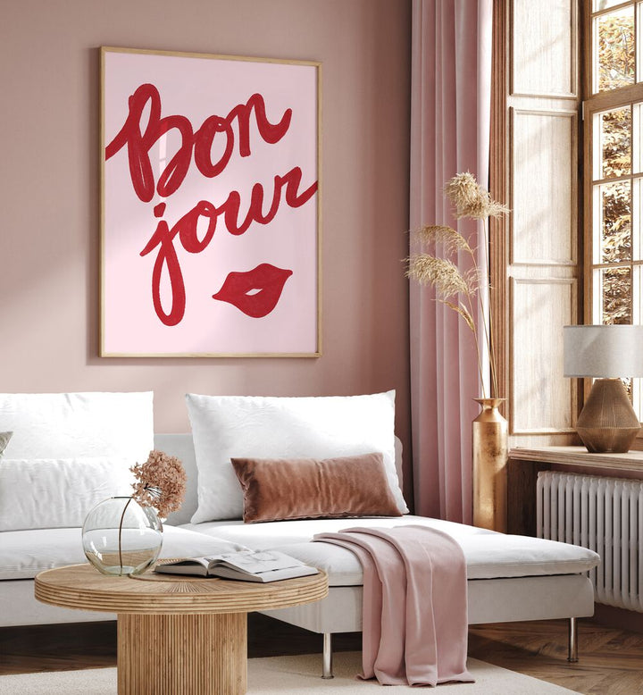 Bonjour Lip by Athene Fritsch Quotes Posters Wall Art Prints in Oak Wood Plain Frame placed on a wall behind a sofa