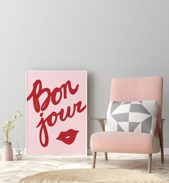 Bonjour Lip by Athene Fritsch Quotes Posters Wall Art Prints in White Plain Frame placed on a floor beside a chair