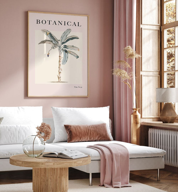 Botanical Palm By Grace Digital Art Co Beach Prints in Oak Wood Plain Frame placed on a pink wall behind a sofa