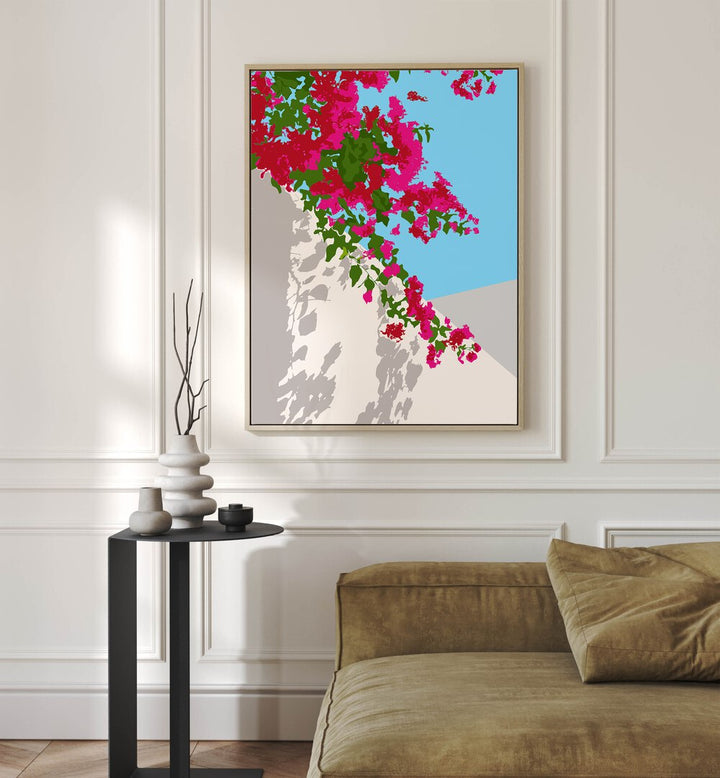 Bougainvillea Blossom By Uma Gokhale Botanical Art Prints in Oak Wood Floater Frame on a white wall behind a sofa