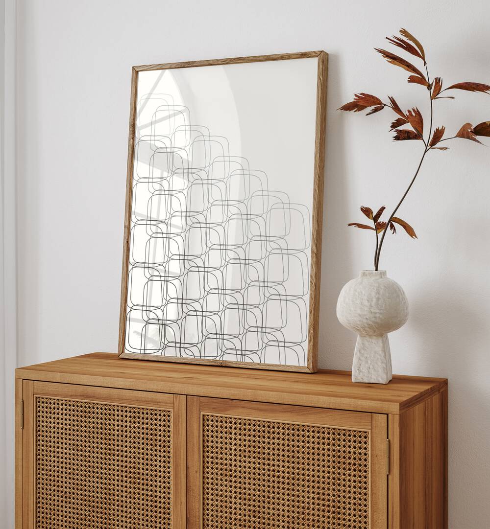 Box In Box By Grishma Korjani Line Art Prints in Oak Wood Plain Frame placed on a Console Table near a White Colored Wall