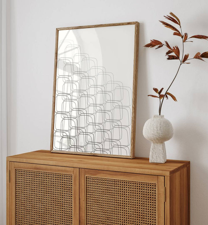 Box In Box By Grishma Korjani Line Art Prints in Oak Wood Plain Frame placed on a Console Table near a White Colored Wall