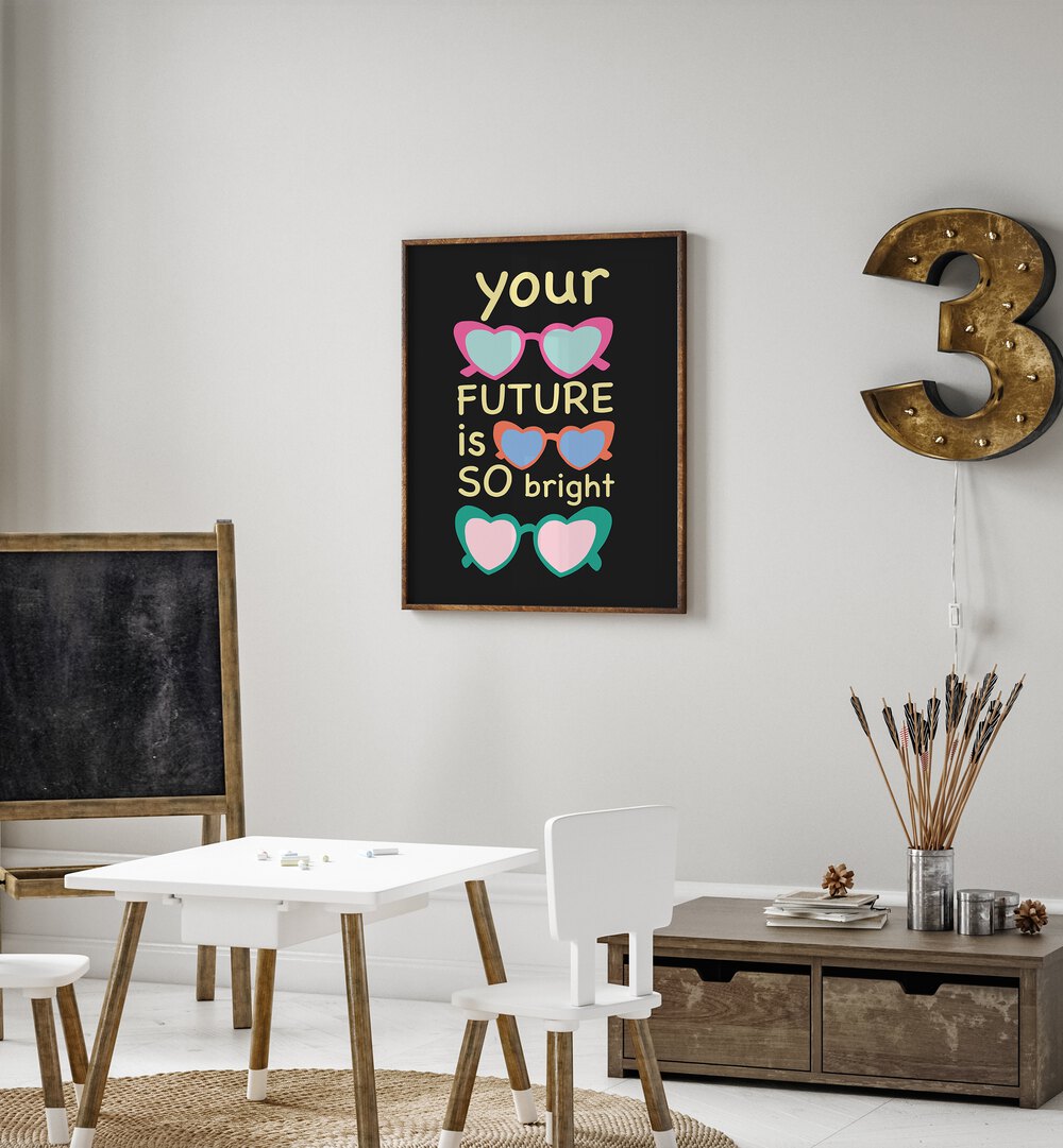 Bright Future Joy by Ania Zwara Quotes Posters Wall Art Prints in Oak Wood Plain Frame placed on a wall in kids room beside a black board