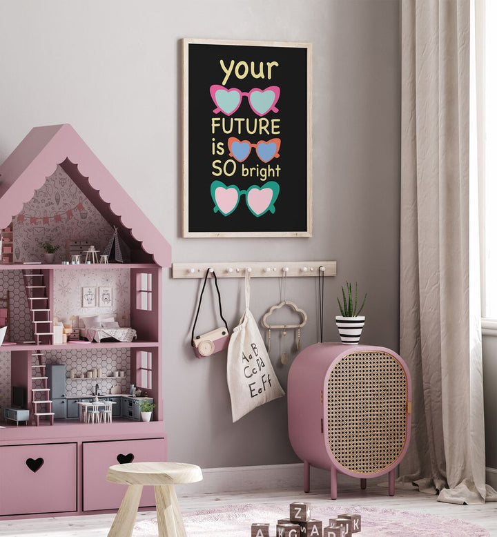 Bright Future Joy by Ania Zwara Quotes Posters Wall Art Prints in Oak Wood Plain Frame placed on a wall beside a doll house in kids room