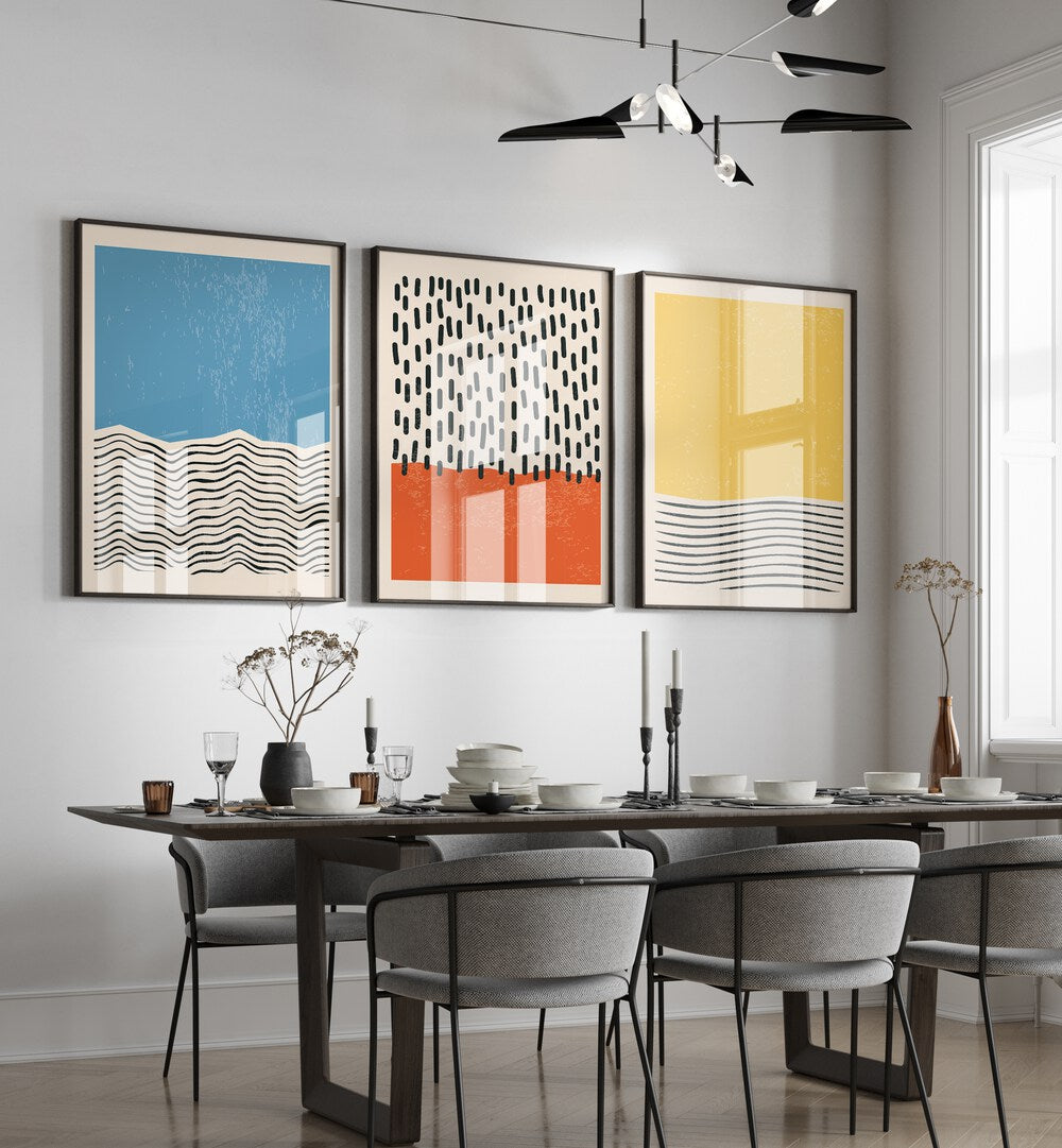 Bright Minimal Set I Set Of 3 Paintings in Black Plain Frame placed on a wall behind a dining table and beside a window for dining area