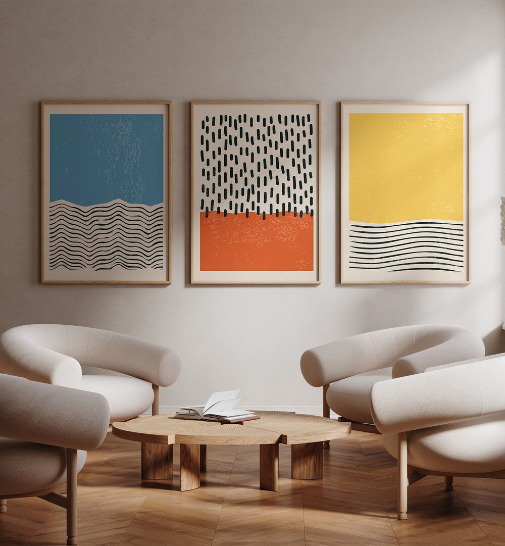 Bright Minimal Set I Set Of 3 Paintings in Oak Wood Plain Frame placed on a white wall behind a white chairs