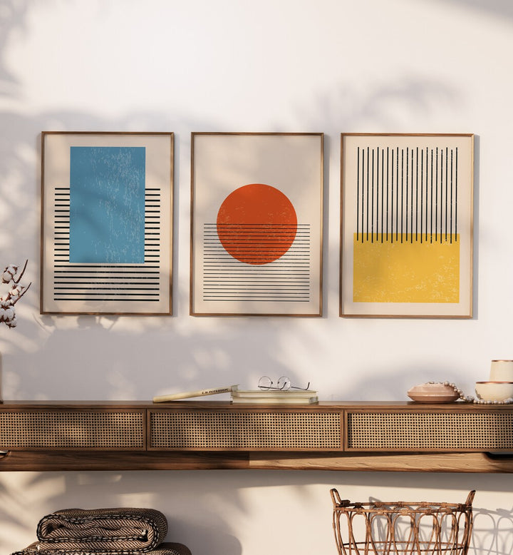 Bright Minimal Set ii Set Of 3 Paintings in Oak Wood Plain Frame placed on a wall behind a table 