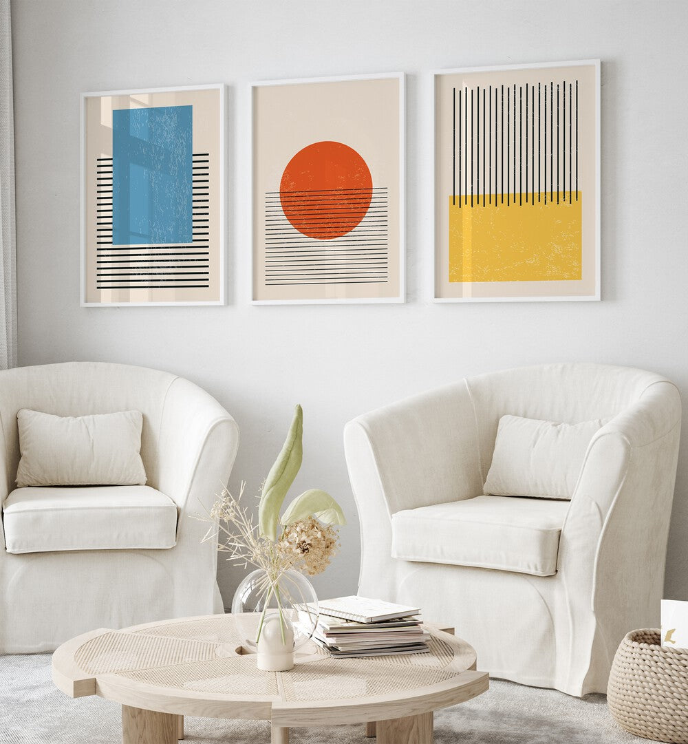 Bright Minimal Set ii Set Of 3 Paintings in White Plain Frame placed on a living room wall behind two  sofas