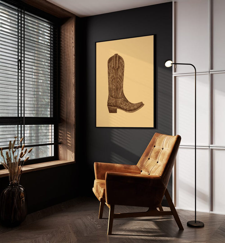 Brown Cowgirl Boot Fashion Paintings Fashion Posters in Black Plain Frame placed on a Dark Grey Colored Wall near a Brown Sofa Chair in the Drawing Room