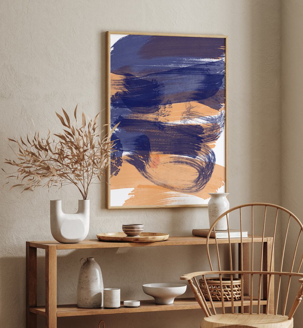 Brushed Sapphire Sunset by Nilesh Kulkarni Abstract Paintings in Oak Wood Plain Frame placed on a wall in the corner of a room behind a table