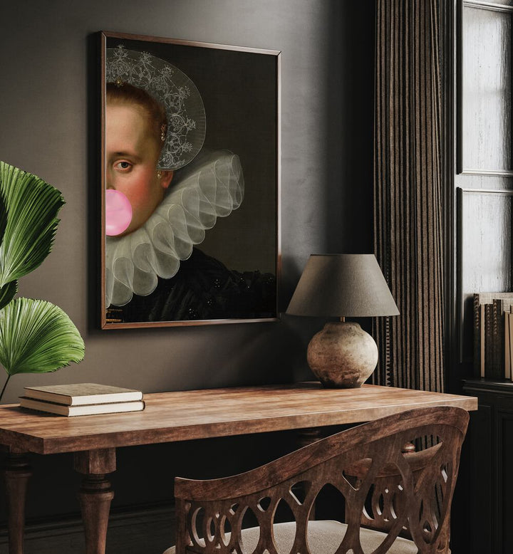 Bubble Gum Queen by the Art Concept Altered Art Prints in Dark Wood Plain Frame placed on a wall behind a study table