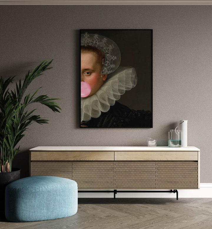 Bubble Gum Queen by the Art Concept Altered Art Prints in Black Plain Frame placed on a wall behind a console table