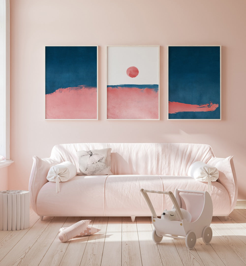 Bubblegum Mist Set Set Of 3 Paintings in White Plain Frame placed on a wall behind a baby pink sofa and beside a window