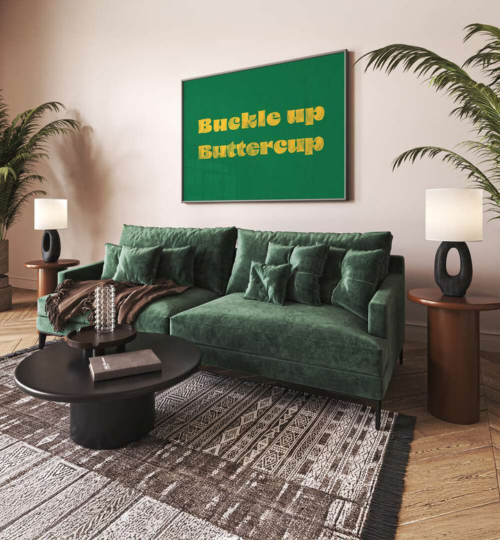 Buckle Up Buttercup Quotes And Typography Posters in Black Plain Frame placed on a Cream Colored Wall near a Green Sofa in the Living Room