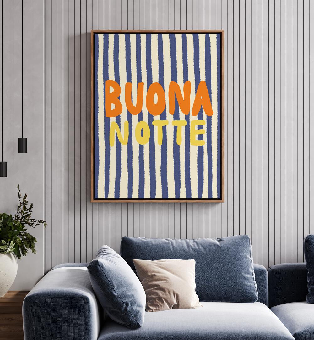 Buona Notte by Studio Dolci Quotes Art Prints in Oak Wood Floater Frame placed on a wall behind a sofa