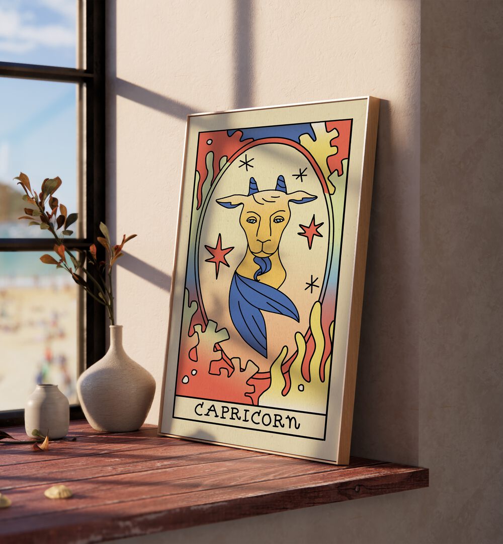 Capricorn Zodiac & Tarot Art Painting Artwork in plain oakwood frame beside a window