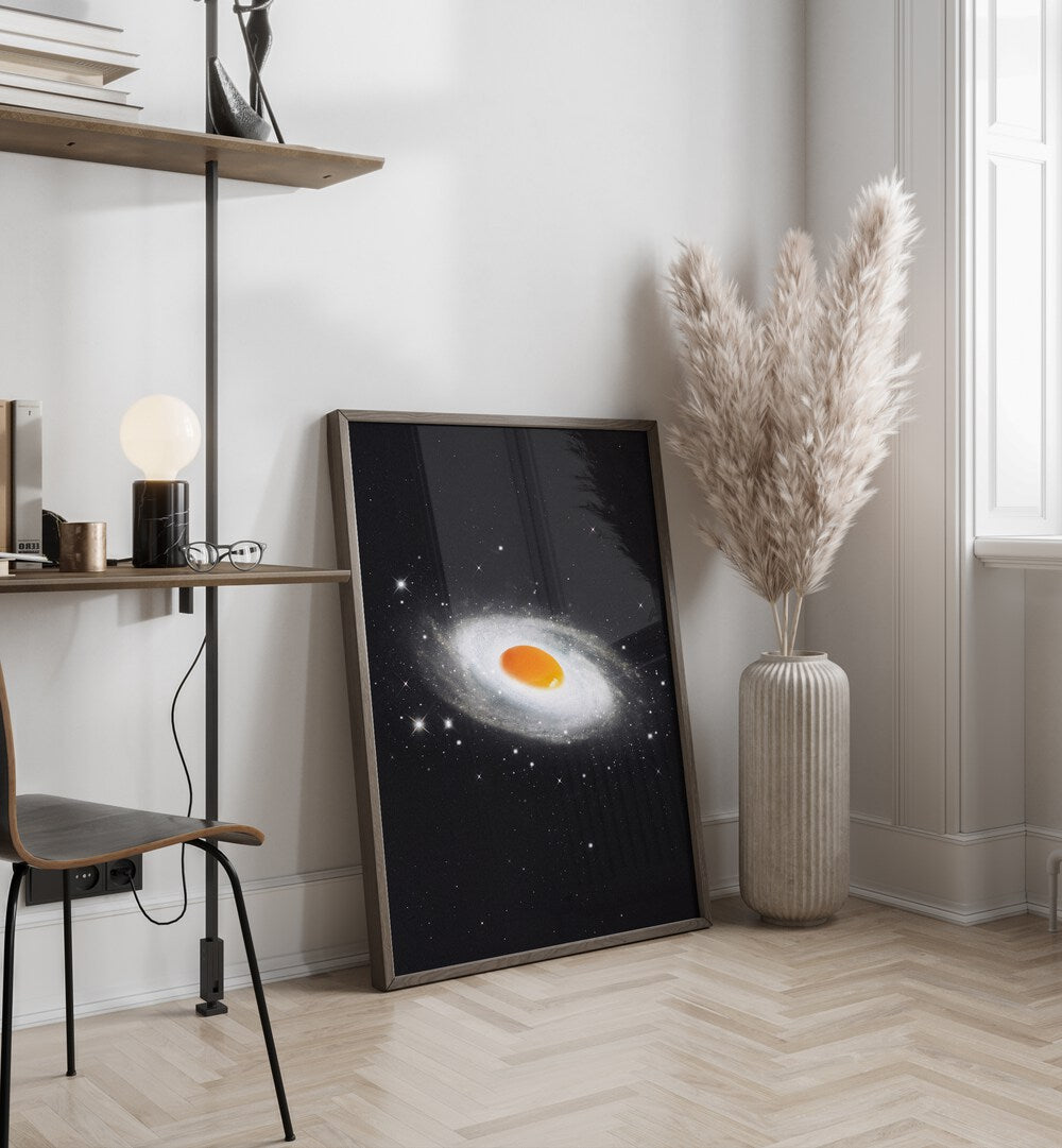 Cosmic Egg Surreal Art Painting Artwork in dark wood frame on a wooden floor beside a flower vase