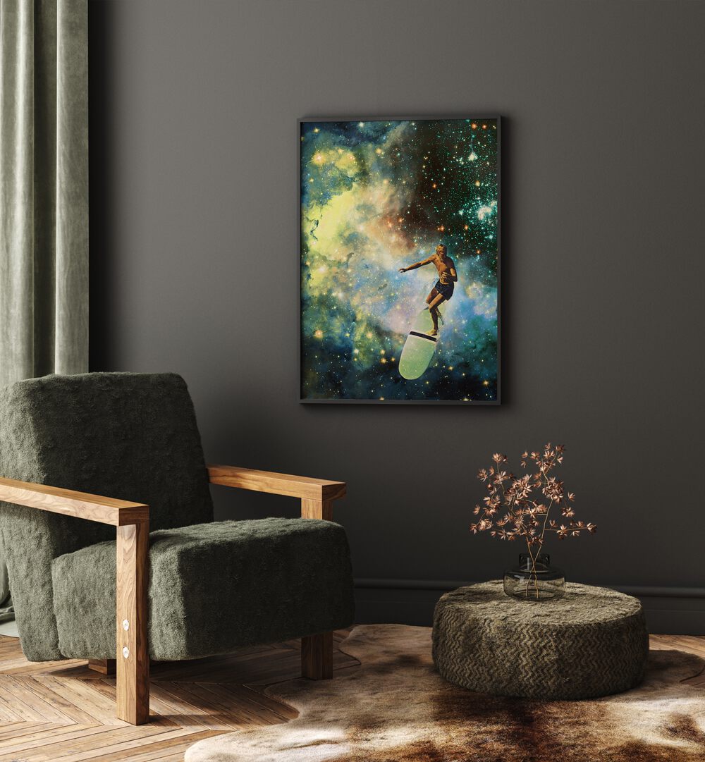 Cosmic Surfer Surreal Art Painting Artwork in plain black frame on a grey wall behind a sofa chair
