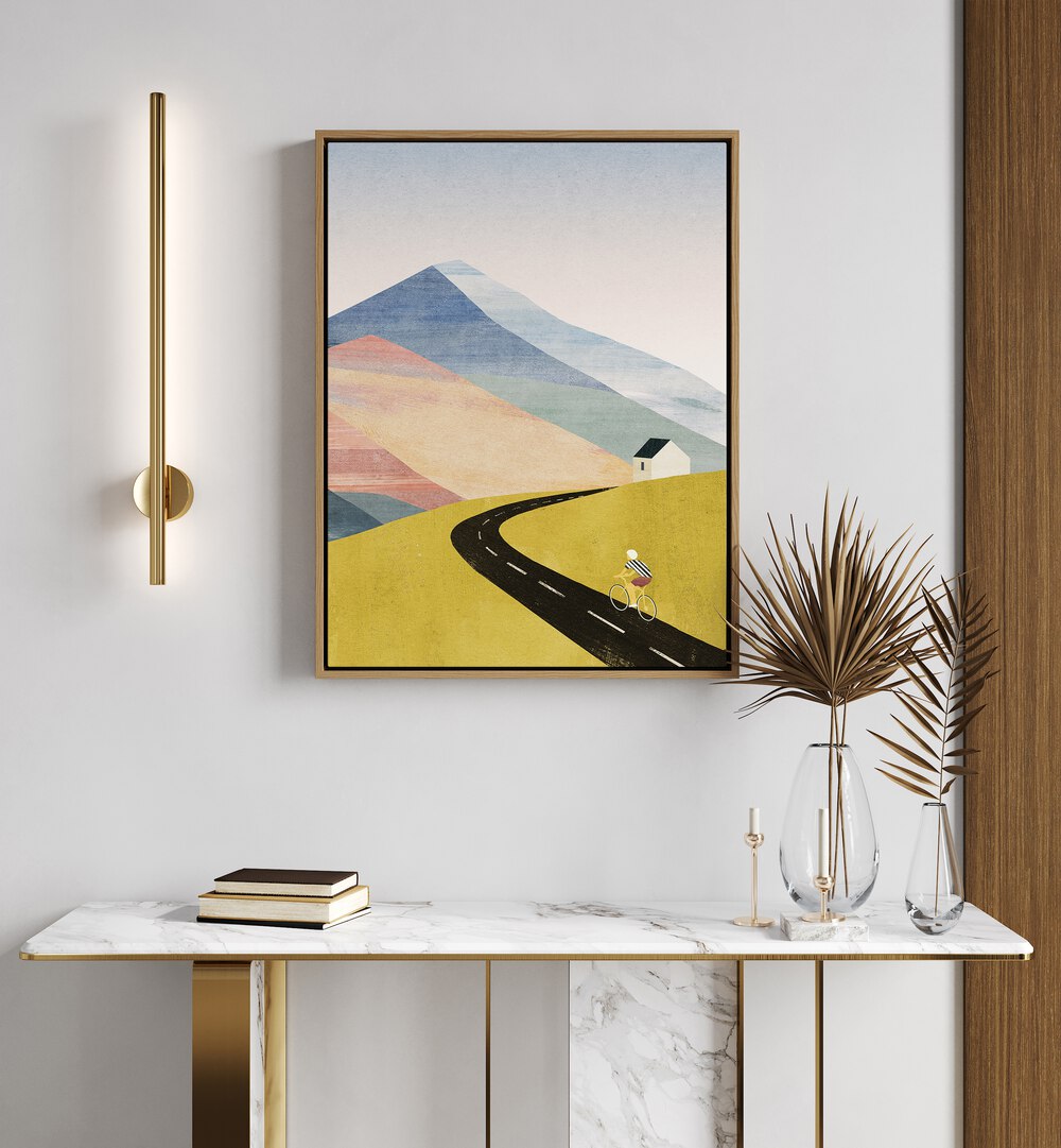 Cycling Home Landscape Art Artwork in Oak Wood Floater Frame Placed on a White Wall Above a White Console Table