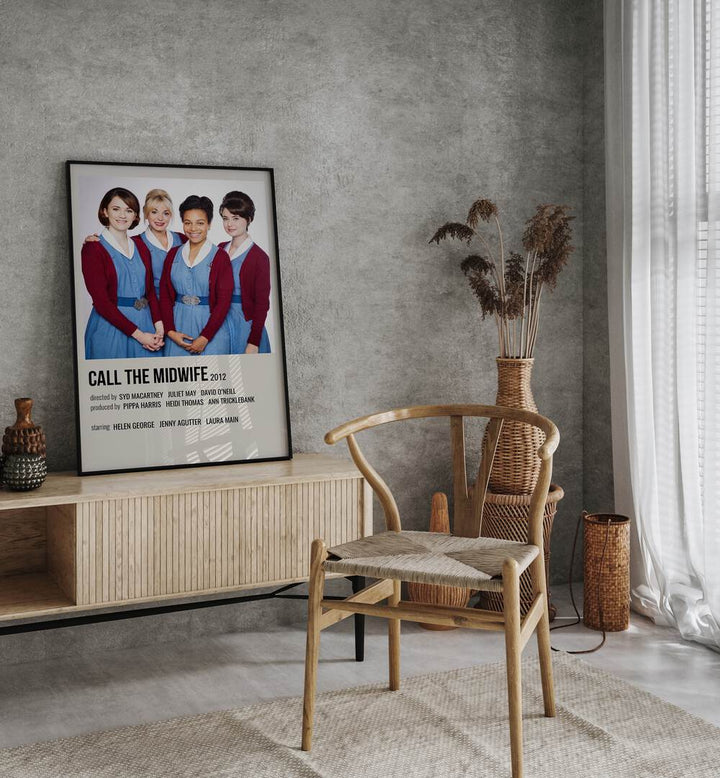 Call The Midwife 2012 Movie Posters in Black Plain Frame placed on a table beside oakwood chair