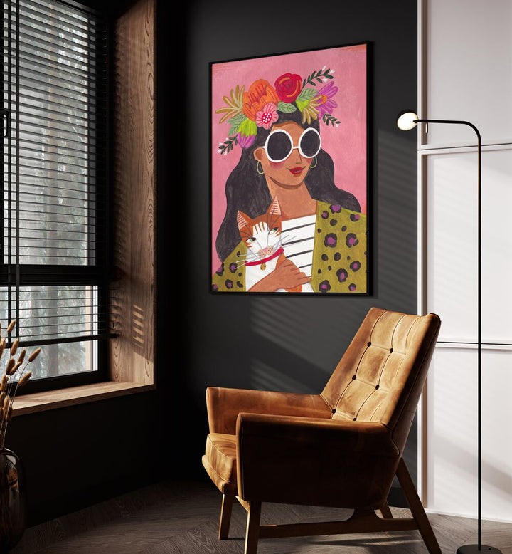 Cat Lady II By Caroline Bonne Muller Women Paintings in Black Plain Frame on a wall beside an orange sofa