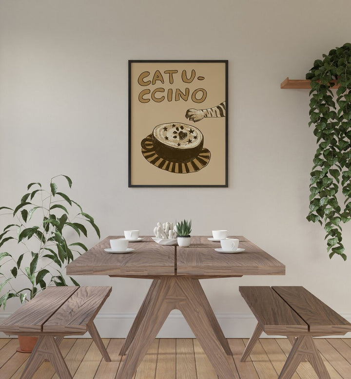 Catuccino by Studio Dolci Cafe Art Prints in Black Plain Frame placed on a wall behind a dining table 