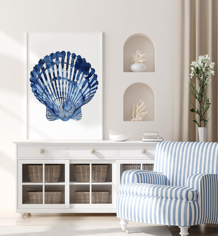 Cerulean Conch I Beach Prints Coastal Wall Art in White Plain Frame placed on a white table beside a sofa