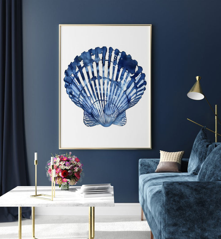 Cerulean Conch I Beach Prints Coastal Wall Art in Oak Wood Plain Frame placed on a blue wall beside a table and a sofa