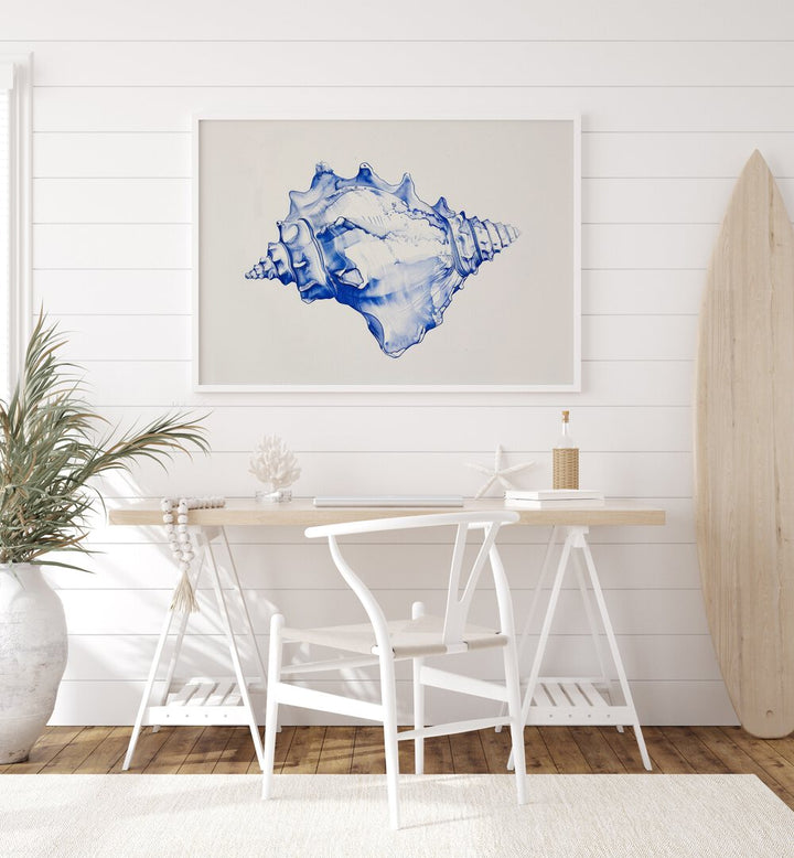 Cerulean Conch Iv Beach Prints Coastal Wall Art in White Plain Frame placed on a white wall behind a table