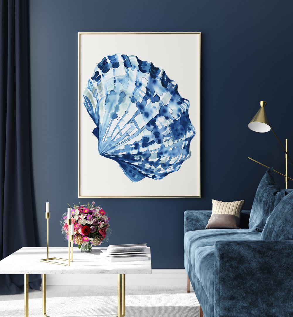 Cerulean Conch ii Beach Prints Coastal Wall Art in Oak Wood Plain Frame placed on a blue wall beside a table and a sofa