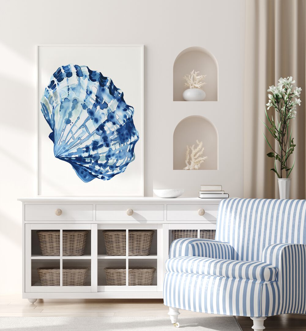 Cerulean Conch ii Beach Prints Coastal Wall Art in White Plain Frame placed on a white table beside a sofa