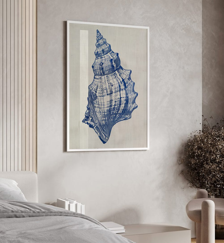 Cerulean Conch iii Beach Prints Coastal Wall Art in White Plain Frame placed on a wall beside a sofa