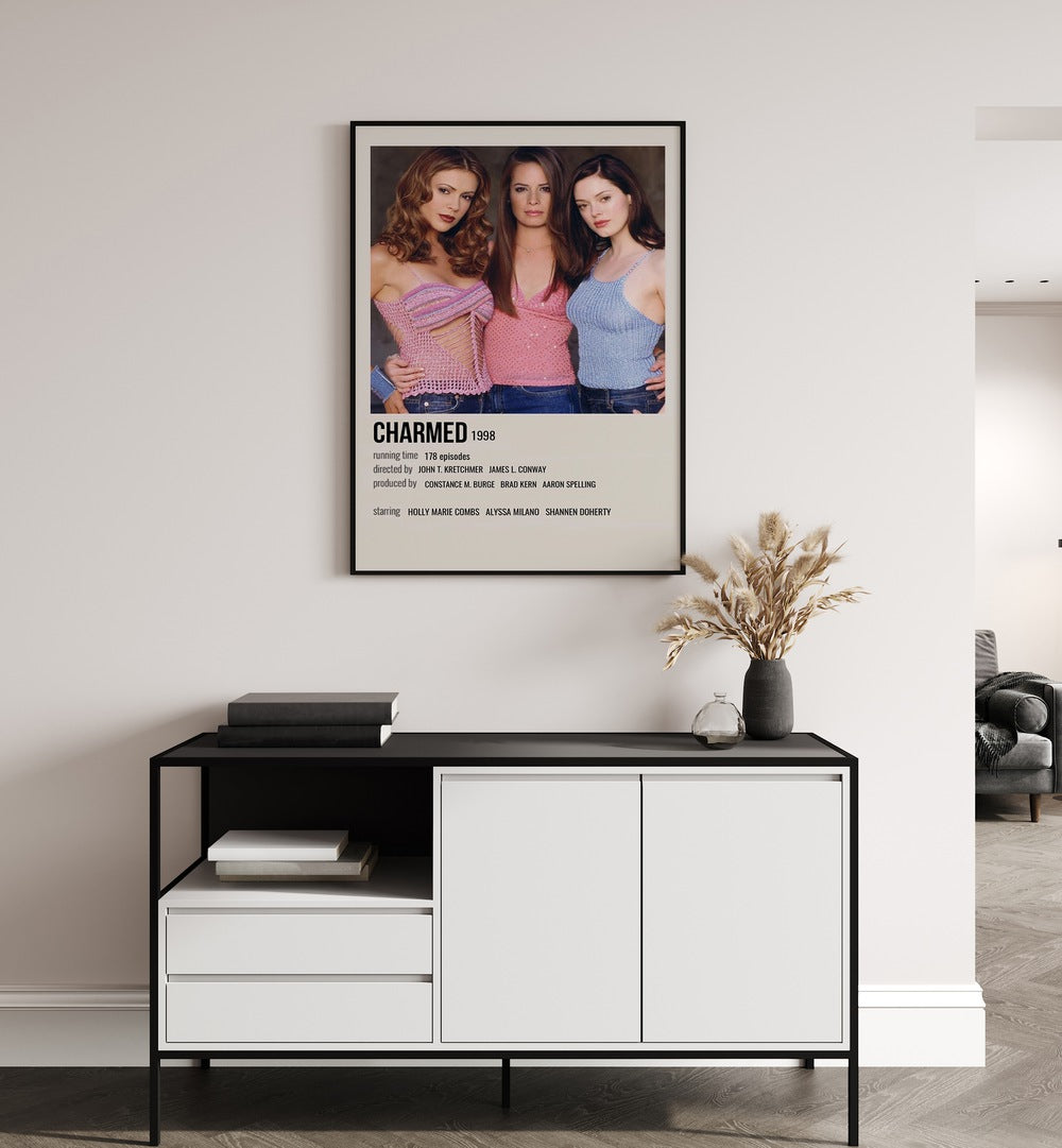 Charmed 1998 Movie Posters in Black Plain Frame hanging on wall above console table