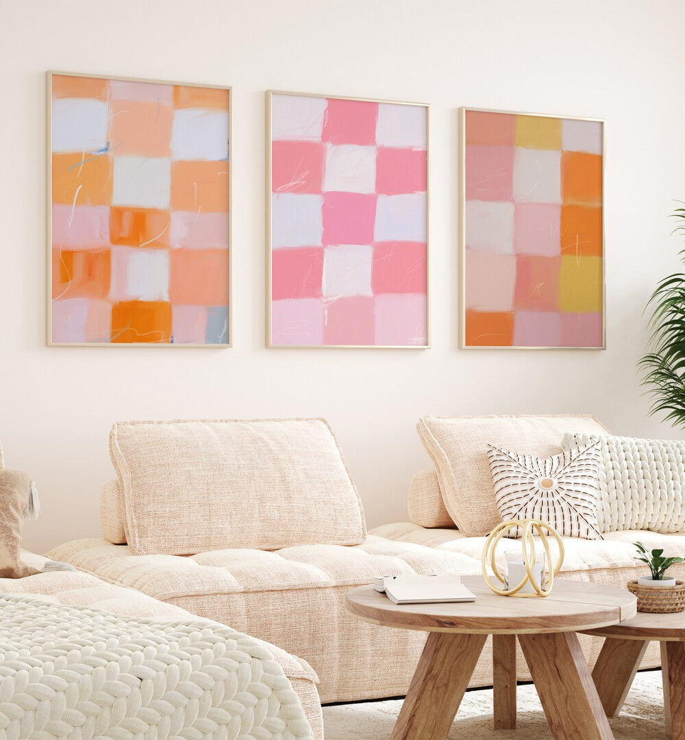 Checkered Colors Set Of 3 Paintings in Oak Wood Plain Frame placed on a living room wall behind a sofa