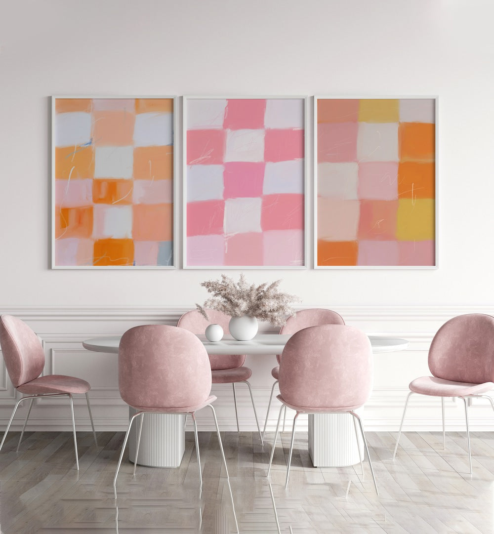 Checkered Colors Set Of 3 Paintings in White Plain Frame placed on a wall behind a dining table for dining area