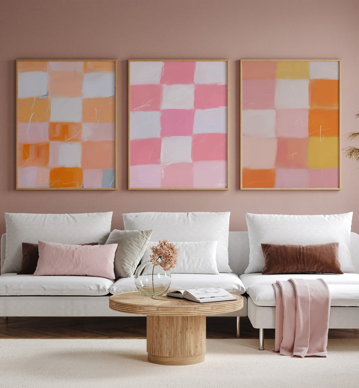 Checkered Colors Set Of 3 Paintings in Oak Wood Plain Frame placed on a living room wall behind a sofa