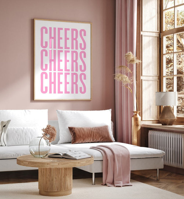 Cheers by Athene Fritsch Cafe Art Prints Cafe Posters in Oak Wood Plain Frame placed on a pink wall beside a window and behind a sofa for living room