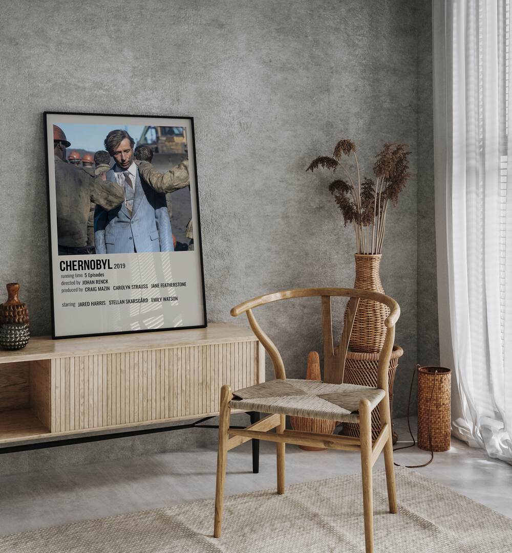 Chernobyl 2019 ii Movie Posters in Black Plain Frame placed on a table beside oakwood chair