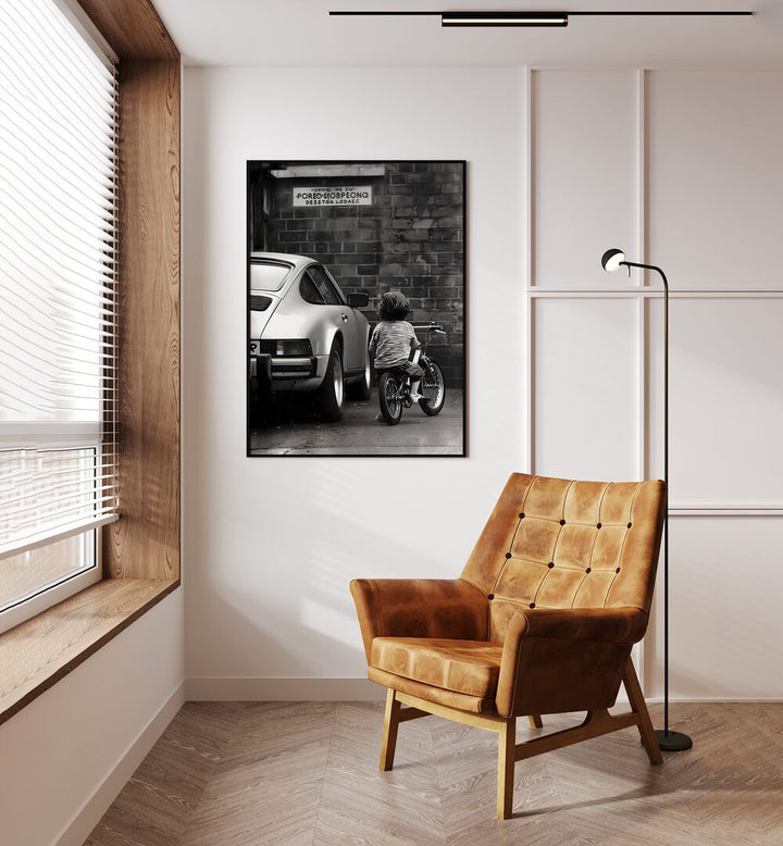 Childhood Dreams Street Photography Fine Art Photography in Black Plain Frame placed on a Cream Colored Wall near a Brown Sofa Chair in the Drawing Room