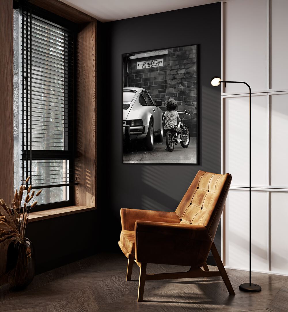 Childhood Dreams Street Photography Fine Art Photography in Black Plain Frame placed on a Dark Grey Colored Wall near a Brown Sofa Chair in the Drawing Room